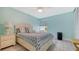 Bedroom with light walls, coastal décor, and wood-look flooring at 7664 Camminare Dr, Sarasota, FL 34238