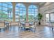 Bright clubhouse with dining tables and chairs, large windows offering views of the outdoors at 7664 Camminare Dr, Sarasota, FL 34238