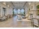 Spacious clubhouse interior with high ceilings, ample seating, a fireplace, and views of the outdoor landscape at 7664 Camminare Dr, Sarasota, FL 34238