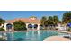 Enjoy a refreshing swim in the sparkling community pool surrounded by palm trees at 7664 Camminare Dr, Sarasota, FL 34238