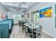 Well-lit dining area with modern decor, booth seating, and large windows with outdoor views at 7664 Camminare Dr, Sarasota, FL 34238