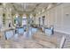 Elegant dining area with high ceilings, large windows and comfortable seating for social gatherings at 7664 Camminare Dr, Sarasota, FL 34238