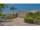 Charming home exterior with brick driveway, two-car garage, and lush landscaping, creating a welcoming curb appeal at 7664 Camminare Dr, Sarasota, FL 34238
