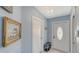 Light and bright entryway featuring a decorative light fixture and bench at 7664 Camminare Dr, Sarasota, FL 34238