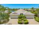 Beautiful villa with a tile roof, paver driveway, two car garage and meticulously maintained landscaping at 7664 Camminare Dr, Sarasota, FL 34238