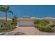 Charming single-Gathering home with a paved driveway and lush tropical landscaping at 7664 Camminare Dr, Sarasota, FL 34238