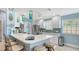 Stylish kitchen with a breakfast bar, pendant lights, and stainless steel appliances at 7664 Camminare Dr, Sarasota, FL 34238