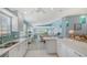 Spacious kitchen with white cabinetry and a breakfast bar open to the living areas at 7664 Camminare Dr, Sarasota, FL 34238