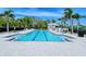 Stay active with the community lap pool and lounge area with inviting seating at 7664 Camminare Dr, Sarasota, FL 34238