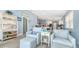 Cozy living area with comfortable seating and seamless transition to the kitchen and dining space at 7664 Camminare Dr, Sarasota, FL 34238