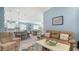 Inviting living room with a view into the kitchen and dining area at 7664 Camminare Dr, Sarasota, FL 34238