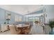 Open-concept living room features a dining area and view of the backyard and pool at 7664 Camminare Dr, Sarasota, FL 34238