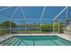 Sparkling pool with screened lanai overlooking the serene waterfront at 7664 Camminare Dr, Sarasota, FL 34238