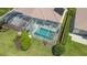 Aerial view of the pool and lanai area. The pool is screened-in and has chairs for relaxing at 7664 Camminare Dr, Sarasota, FL 34238