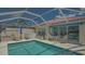 Screened-in pool area with comfortable seating, perfect for relaxing and entertaining outdoors near the refreshing pool at 7664 Camminare Dr, Sarasota, FL 34238