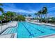 Well-maintained community pool with lane markers perfect for swimming laps on a sunny day at 7664 Camminare Dr, Sarasota, FL 34238