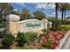 Attractive entrance sign to VillageWalk at Palmer Ranch with colorful landscaping and vibrant flowers at 7664 Camminare Dr, Sarasota, FL 34238