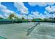 Well-maintained tennis courts with green surface and tall fences, perfect for recreational play at 7664 Camminare Dr, Sarasota, FL 34238