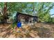 Mature trees surround a screened-in porch in a backyard setting at 826 Lillian Ln, Sarasota, FL 34243