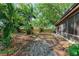 Fenced backyard with mature trees and screened-in lanai at 826 Lillian Ln, Sarasota, FL 34243
