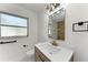 Modern bathroom featuring sleek vanity, stylish mirror and elegant fixtures at 826 Lillian Ln, Sarasota, FL 34243