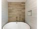 Modern bathroom features a freestanding tub, decorative tile and custom shelving at 826 Lillian Ln, Sarasota, FL 34243