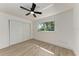 Bedroom featuring wood-look floors, a ceiling fan, and closet space at 826 Lillian Ln, Sarasota, FL 34243