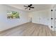 Inviting bedroom featuring a ceiling fan, large window, and two spacious closets at 826 Lillian Ln, Sarasota, FL 34243