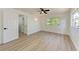 Bright bedroom features wood-look floors, ceiling fan, and ample natural light at 826 Lillian Ln, Sarasota, FL 34243