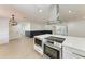 Modern kitchen featuring a large island with cooktop, stainless steel appliances, and an open floor plan at 826 Lillian Ln, Sarasota, FL 34243