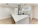 Bright, newly remodeled kitchen with a large white marble island and stainless steel appliances at 826 Lillian Ln, Sarasota, FL 34243
