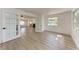 Bright and open living space with new flooring, modern doors, and large windows at 826 Lillian Ln, Sarasota, FL 34243