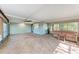 Enclosed patio featuring a hot tub, ceiling fan, and tile flooring at 826 Lillian Ln, Sarasota, FL 34243
