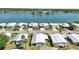 Aerial view of homes in a lakeside community with well-manicured lawns and mature palm trees at 8534 Imperial Cir, Palmetto, FL 34221