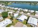 Aerial view of homes in a lakeside community with well-manicured lawns and mature palm trees at 8534 Imperial Cir, Palmetto, FL 34221