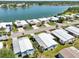 Aerial view of homes in a lakeside community with well-manicured lawns and mature palm trees at 8534 Imperial Cir, Palmetto, FL 34221
