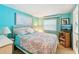 Inviting bedroom featuring bright walls, comfortable bedding, and a convenient entertainment center at 8534 Imperial Cir, Palmetto, FL 34221