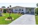 Inviting home with a well-kept lawn, colorful landscaping, and a spacious covered driveway at 8534 Imperial Cir, Palmetto, FL 34221