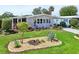 Well-maintained home showcases vibrant landscaping, manicured lawn, and a welcoming covered carport at 8534 Imperial Cir, Palmetto, FL 34221