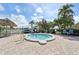 Community hot tub with lake views, seating, and a tiki hut nearby, perfect for relaxing outdoors at 8534 Imperial Cir, Palmetto, FL 34221