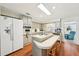 Bright kitchen featuring an island cooktop, white appliances, and ample counter space at 8534 Imperial Cir, Palmetto, FL 34221