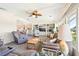 Spacious living room with a ceiling fan, built in shelving, and comfortable seating at 8534 Imperial Cir, Palmetto, FL 34221