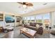 Comfortable living room featuring large windows, built-in shelving, and ample seating for relaxation at 8534 Imperial Cir, Palmetto, FL 34221