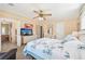 Comfortable main bedroom with a ceiling fan, dresser, and easy access to the bathroom at 8534 Imperial Cir, Palmetto, FL 34221