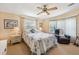 Cozy main bedroom featuring a ceiling fan, comfortable seating, and plenty of natural light at 8534 Imperial Cir, Palmetto, FL 34221