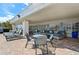 Covered outdoor patio with tables, chairs, lounge seating, and pool chairs; great for entertaining at 8534 Imperial Cir, Palmetto, FL 34221