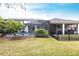 Backyard with a pool, screened-in patio, manicured lawn, and metal fence at 1007 143Rd Ne St, Bradenton, FL 34212
