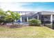 Relaxing backyard featuring a screened-in pool, lush lawn, and mature trees at 1007 143Rd Ne St, Bradenton, FL 34212