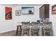 Basement bar with stone counter, barstool seating, wall decor, and TV entertainment at 1007 143Rd Ne St, Bradenton, FL 34212