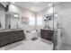 Bright bathroom featuring double vanities, a soaking tub, and a glass-enclosed shower at 1007 143Rd Ne St, Bradenton, FL 34212
